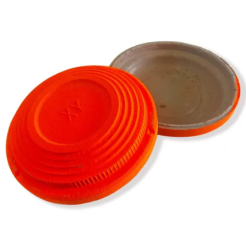 Top and bottom view of a single orange clay target